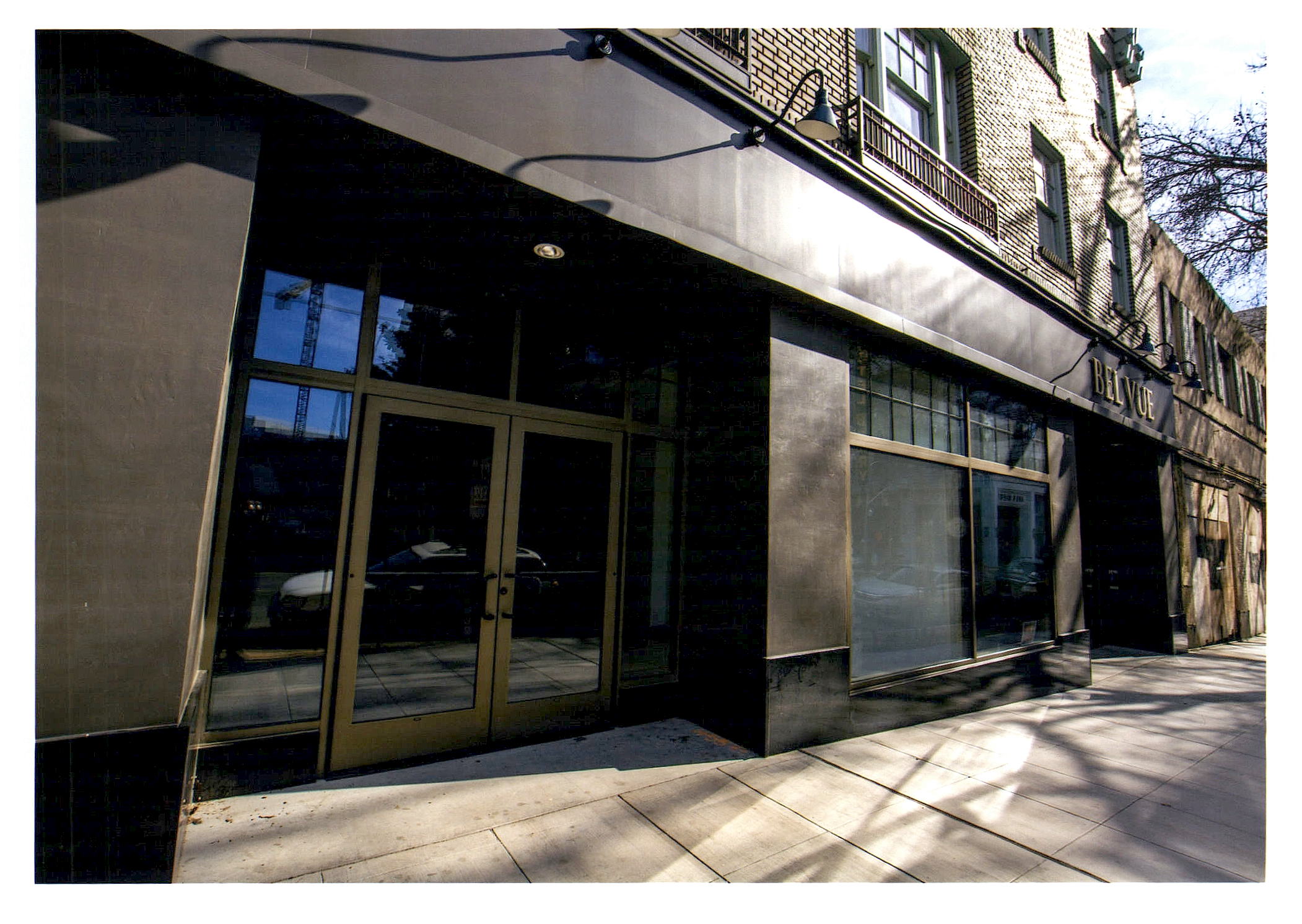 After: sidewalk view of new compatible storefronts. The structural seismic upgrade is integrated into the facade.